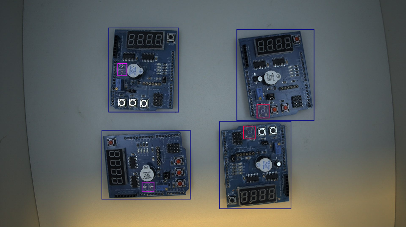 An example showing defective printed circuit boards annotated with bounding boxes.