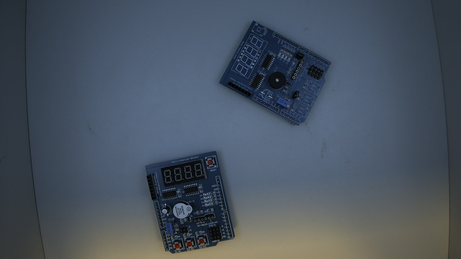 Source image showing two PCB boards on a table